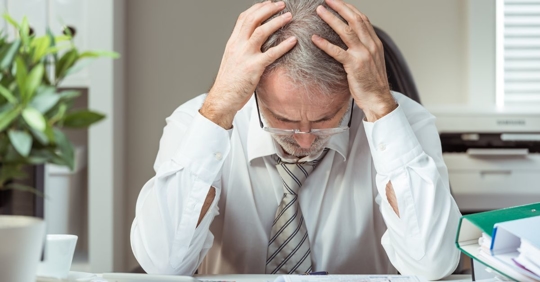 man stressed over debt